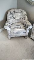 Full view of the fabric covered armchair with patterned design and cushioned arms and seat.