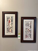 Photo of two vertically oriented framed prints hanging side by side on a wall with matching frames and double matting.