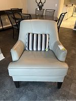 Front view of armchair with throw cushion