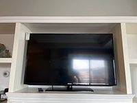 Samsung 46-inch TV displayed on stand with remote.