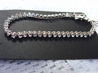 Full view of the bracelet laid flat on a black background