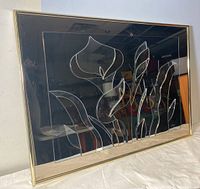 Framed wall mirror showing the overall 3D floral bas-relief design and gold-tone metal frame.