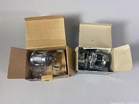 Top-down photo showing both reels in their original open boxes, revealing packaging and reels inside.