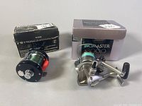 Both reels side by side with original boxes visible