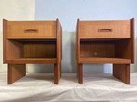 Front view of both end tables side by side showing drawers and shelves