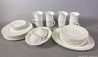 Overview of all dishes including embossed Countryware pieces and plain white plates