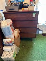 Front view of the Mid-Century Modern style wooden dresser showing its four drawers and the unique drawer front design.