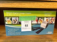 Front of product box showing product name, brand, model number, and features: easy image transfer software, digitizes slides and 110/135 film, plug & play driver free.