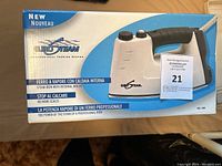 Photo of the box showing the Euro Steam steam iron with internal boiler in original packaging.