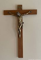 Full view of wooden crucifix with metal Jesus figure and INRI plaque