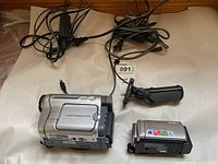 Overview of both camcorders with handgrip and power adapter