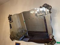 Overall view of wall mirror mounted on wall, showing reflective surface and placement.