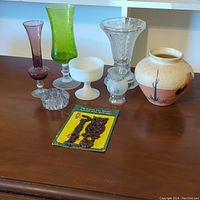 Full lot on wooden surface showing all six vases, the vintage owl wall bracket in packaging, and clear flower frog.