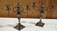 Pair of silver plated combination candelabras fully assembled with three candle holders each.