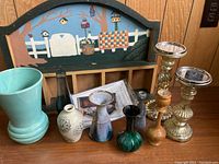 Full view of collection showing McCoy vase, candle holders, bud vases, and folk art wall decor in background