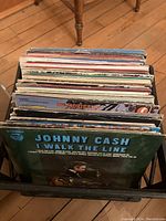 Full milk crate of vintage LP vinyl records with visible Johnny Cash album 'I Walk the Line' on front.