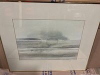 Front view of the framed watercolour print showing the coastal landscape in muted grey tones.