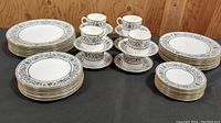 Complete set showing plates, cups and saucers arranged stacked by size and grouped by type