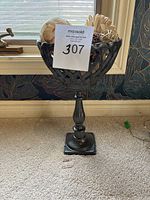 Full side view showing the pedestal garden planter urn with a lattice pattern and black finish.