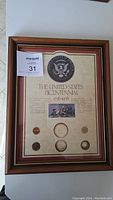 Framed United States Bicentennial coin and stamp set showing all coins and stamps in display.