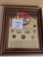 Framed 1984 Canadian World War II Collection featuring 7 coins and 2 stamps commemorating the 40th anniversary of D-Day, with Canadian and British flags and a ship illustration on background paper.