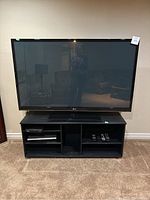 LG flat screen TV on black TV stand