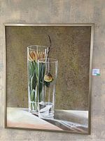 Full view of framed painting showing two glass vases with yellow tulips and a decorative branch against a textured muted background.