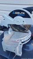 Front angle view of the Delta 10-inch chop saw showing the blade, base and angle settings.