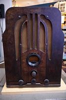 Front view of vintage 1937 Philco tombstone radio showing tall wooden cabinet with grille.