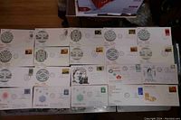 Photo showing a spread of multiple Canadian First Day Covers with various stamps and postmarks from the 1960s and 1970s.