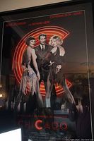 Full view of Chicago movie poster in black frame showing three actors with visible autograph signatures on poster.