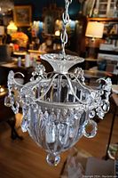 Full view of the crystal hall light showing silver finish, crystal beads, and hanging pendants.