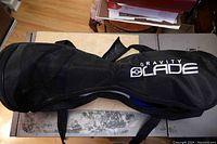 Black Gravity Blade branded carry bag, zippered and laid flat on surface.