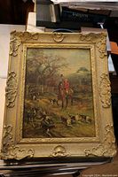 Full view of the framed print showing the decorative gold frame and hunting scene in detail.