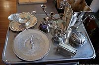 Full view of 11 silver plate pieces arranged on large rectangular serving tray.