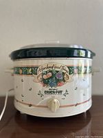 Front side view of the Rival crock-pot showing decorative pattern and control dial.