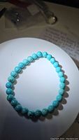 Photo of natural robin's egg blue turquoise bead stretchy bracelet laid flat showing round polished beads.