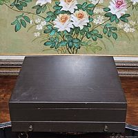 Closed wooden flatware case with dark finish