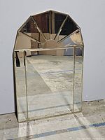 Front view of large rectangular mirror with starburst top detail.