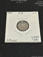 Reverse showing the crowned numeral '3' and wreath on the 1900 GB silver 3 pence coin in white holder.