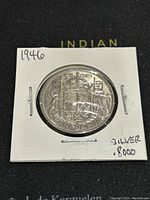 1946 Canadian 50 cent coin reverse side showing coat of arms, silver content marked .8000 and year 1946.