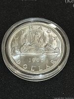 Reverse side showing Canadian canoe design with year 1965 and denomination 1 Dollar.