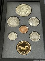 Orientation showing front designs of the seven coins in the set, including detailed reverse designs.
