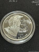 Obverse side showing two historical figures and a sailing ship with the inscription 'CANADA DOLLAR 1995'. Proof condition, 92.5% silver.