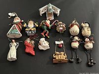 Full view of all 13 assorted Christmas ornaments arranged on black background