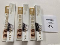 Three Velour Pretty Big Deal Peptide & Tubing Mascaras in their original white packaging, each showing product information and before/after eyelash images.