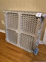 Full view of a large light gray plastic panel of the Summer Infant baby play pen, showing the structure and connection points.