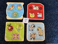 Overview of all four wooden animal-themed baby puzzles with wooden knobs, showing one puzzle still sealed.