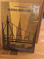 Front view of Queens Boulevard metal art print showing bridge illustration and title text