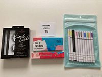 Overview of all items showing the Eylure London lashes, Silly George lashes and liners, and 11 colorful adhesive eyeliners in original packaging.